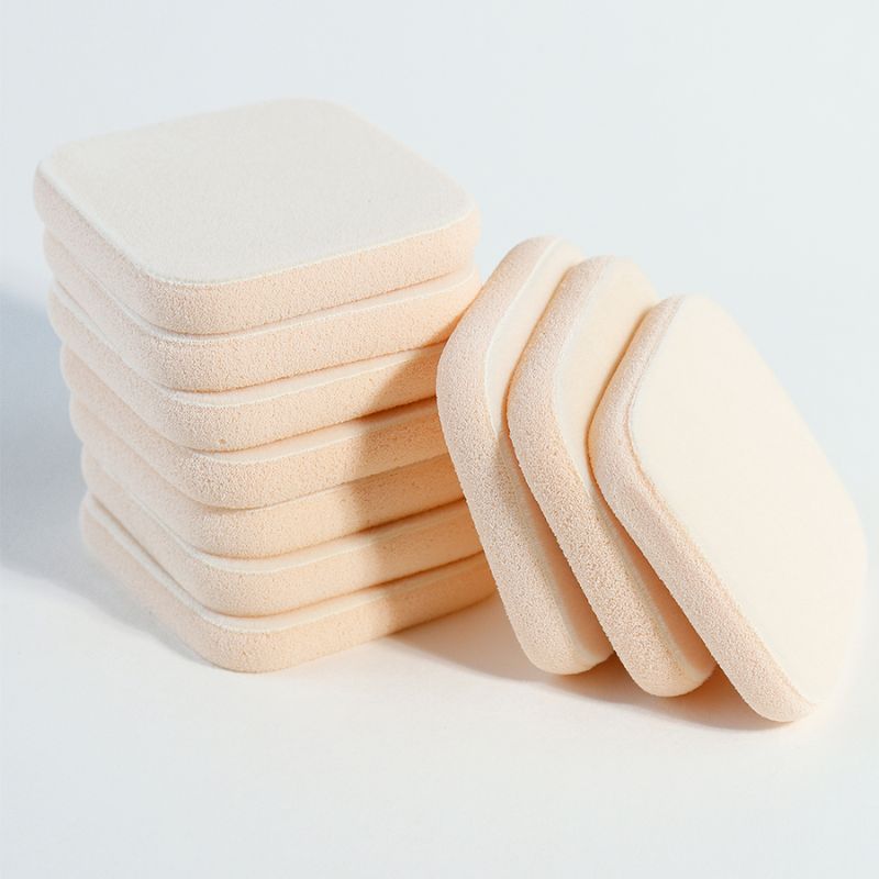 Dual-layer compact puff with soft top and firm base in beige. Ensures consistent powder pickup and release — scalable from 5,000 pcs with FDA-compliant materials